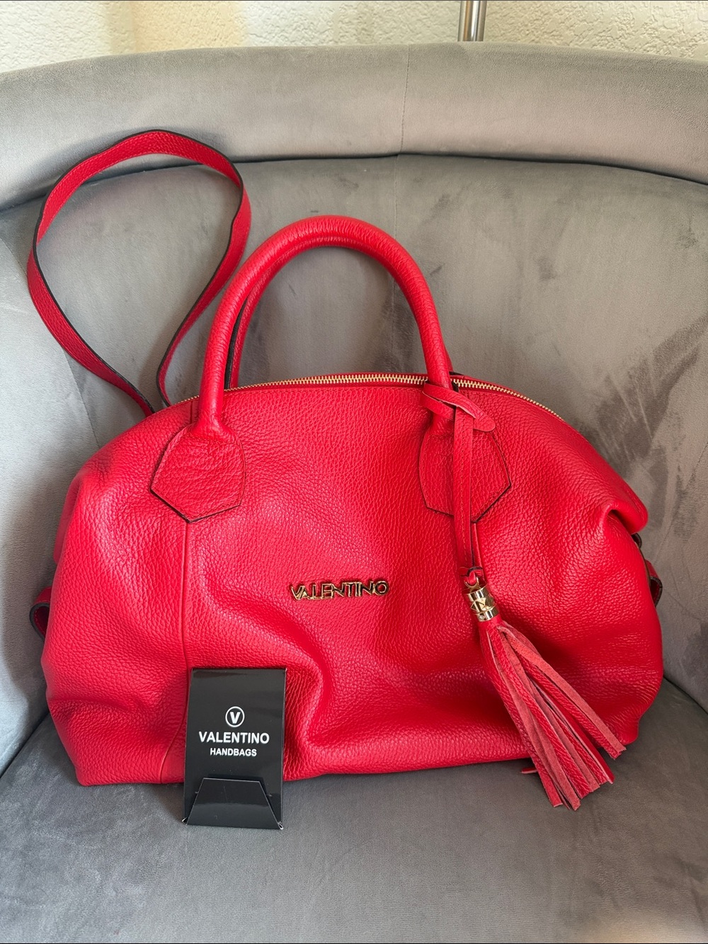 Mario Valentino Vibrant Red Pebbled Leather Satchel with Tassel Accent.